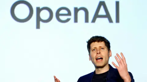 Reuters OpenAI CEO Sam Altman speaking on a stage gesturing with his hands.