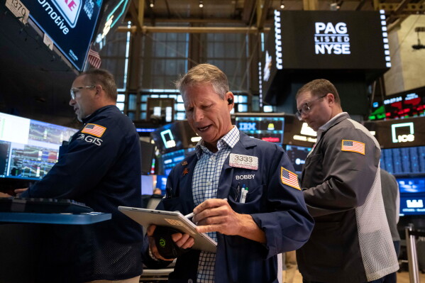 Trader Robert Charmak works on the floor of the New York Stock Exchange in New York, Friday, Aug. 21, 2026. (AP Photo/Yuki Iwamura)