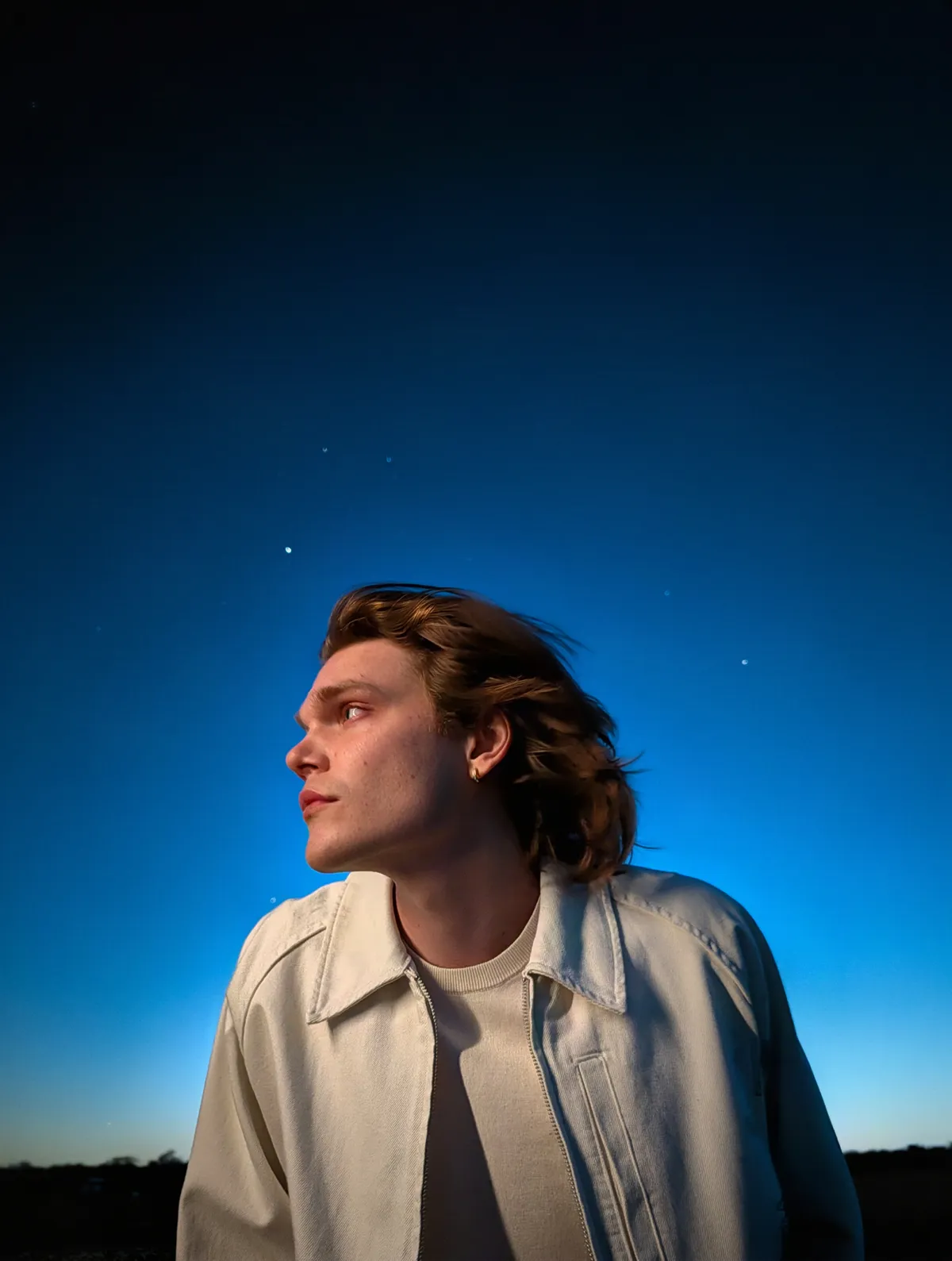 Instant Night Sight capturing a man posing under the stars