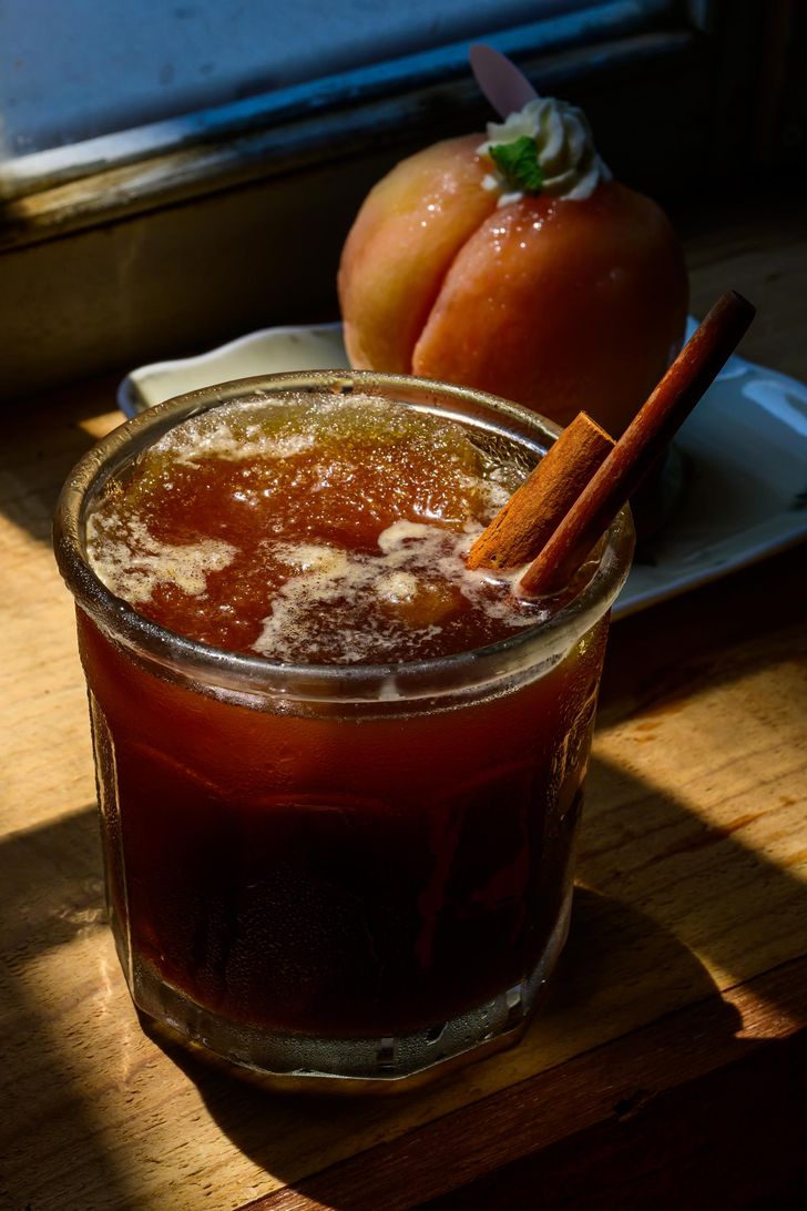 Coffee Hanyakbang's signature drinks include a unique reinterpretation of 'sujeonggwa,' a traditional Korean cinnamon, ginger and persimmon punch, and pairs well with the peach tart at the cafe in Jung District, Seoul, Aug. 3. Korea Times photo by Choi Won-suk