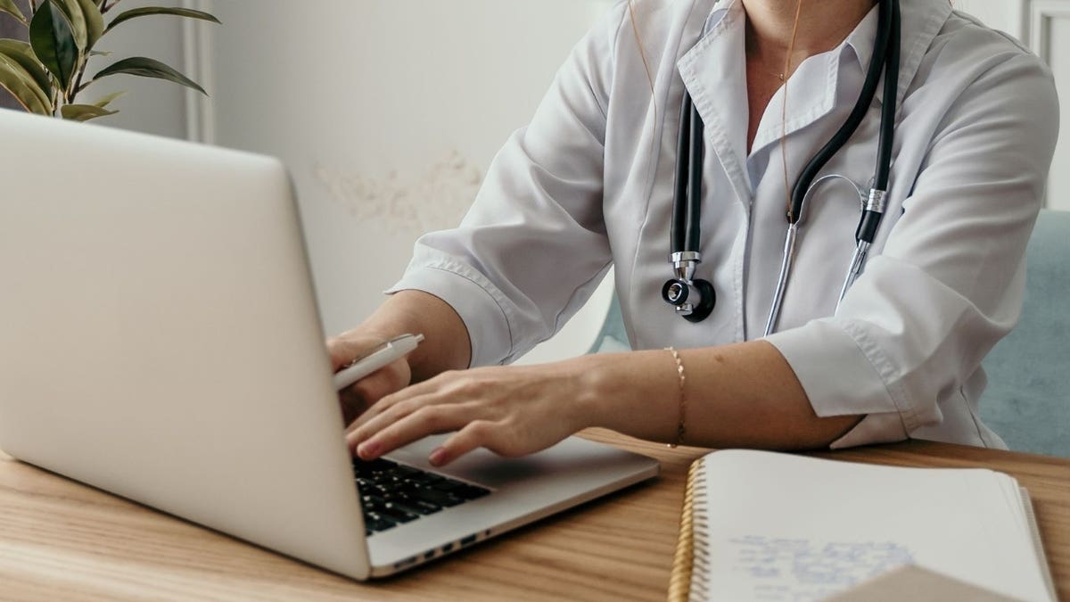 A doctor on a computer