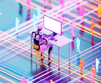 A robot works at an office desk with human workers in the background